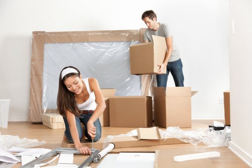 Professional movers loading furniture into a van in South Kensington