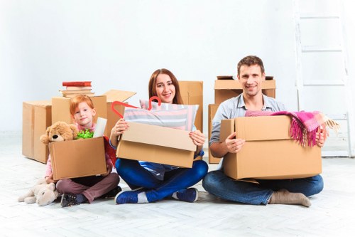 Moving team carrying furniture for a man and van job in South Kensington