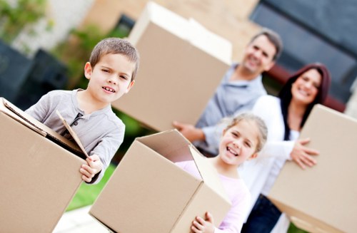 Professional movers carrying boxes in a South Kensington apartment building